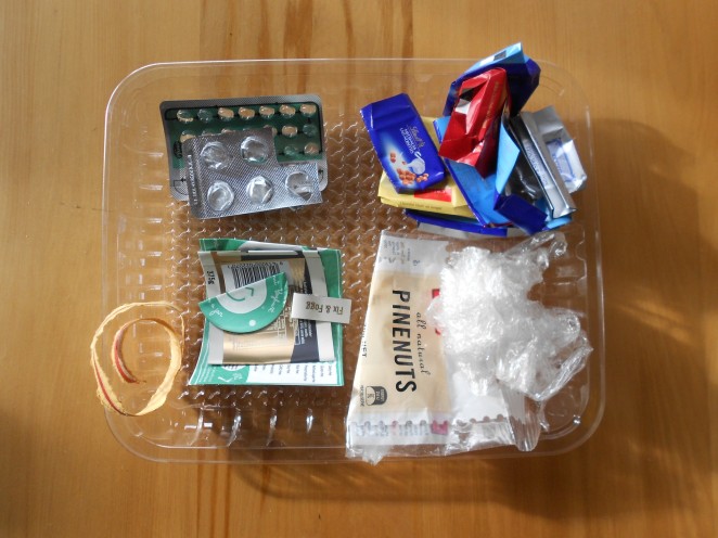 Plastic packaging from July - pill packets, meat tray, chocolate wrappers, and jar stickers